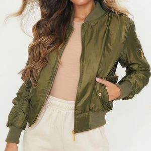 An army green jacket with a gold zipper! It has orange in the inside!